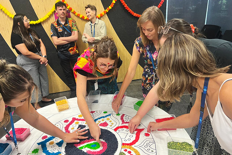 A group of employees complete an activity in celebration of Diwali